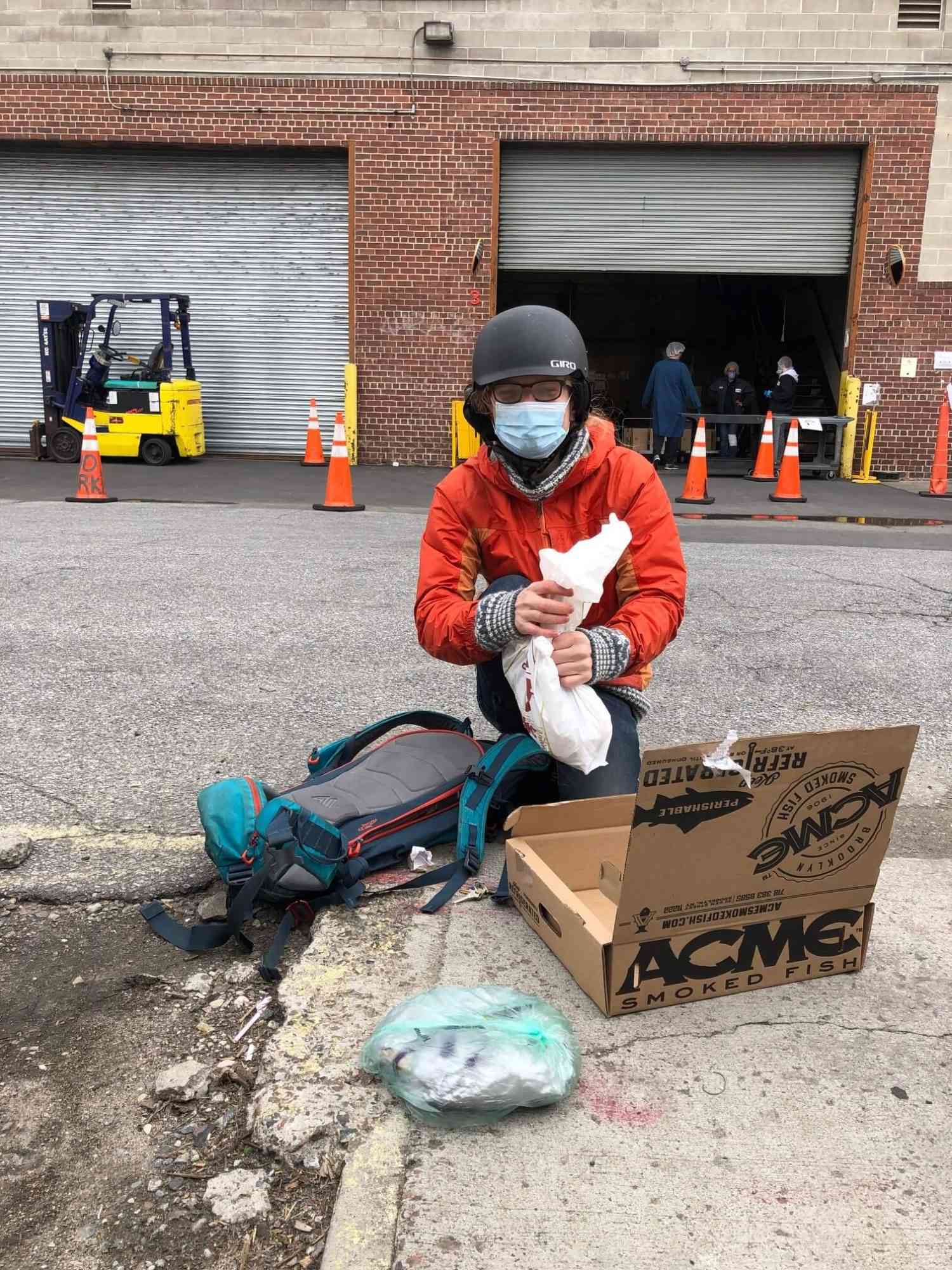 Daniel with some smoked fish on a sidewalk