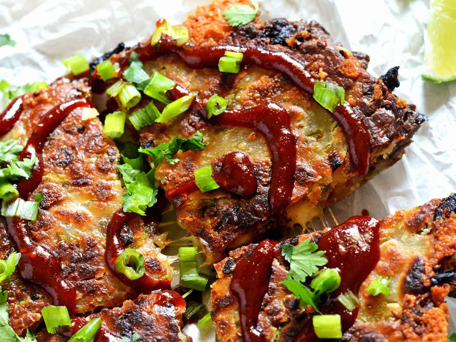 Overhead close-up of a quartered bulgogi scallion pancake-adilla.
