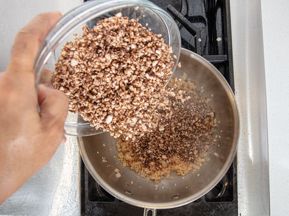 Overhead view of adding mushrooms