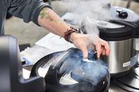 Person adjusting steam valve of Instant Pot 6-Quart Max 9-in-1 Pressure Cooker