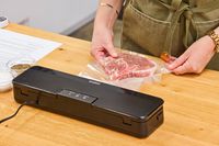 A bag of meat is vacuum seal using the Anova Precision Sous Vide Vacuum Sealer