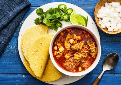Overhead view of menudo rojo in a bowl in a plate