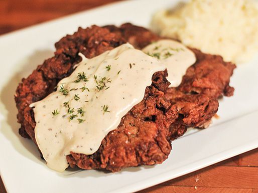 Pepper gravy spooned on chicken fried steak, served with mashed potatoes.