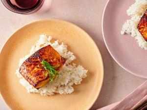 Miso glazed salmon served over white rice on a plate