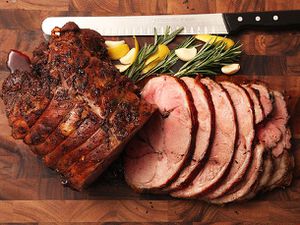 A sliced leg of lamb on a cutting board.