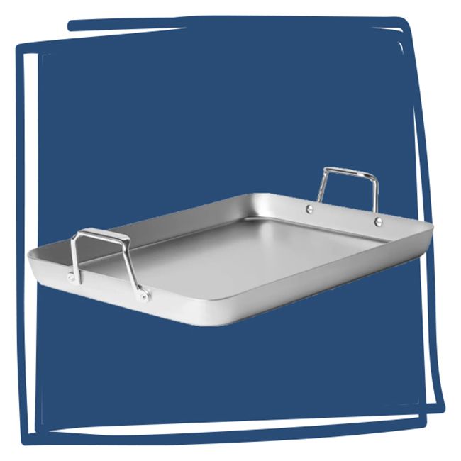 A metal roasting pan with two handles on a blue background