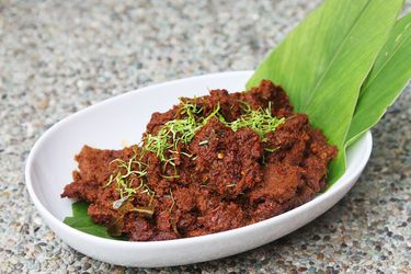 Beef rendang in an oval white bowl 