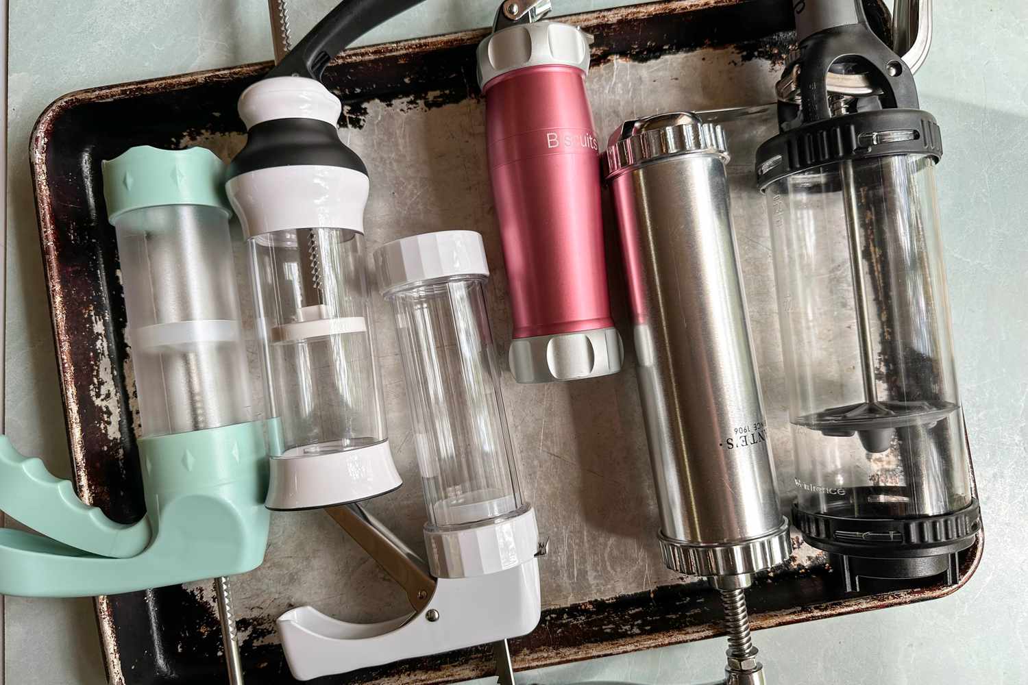 Various cookie presses arranged on a tray