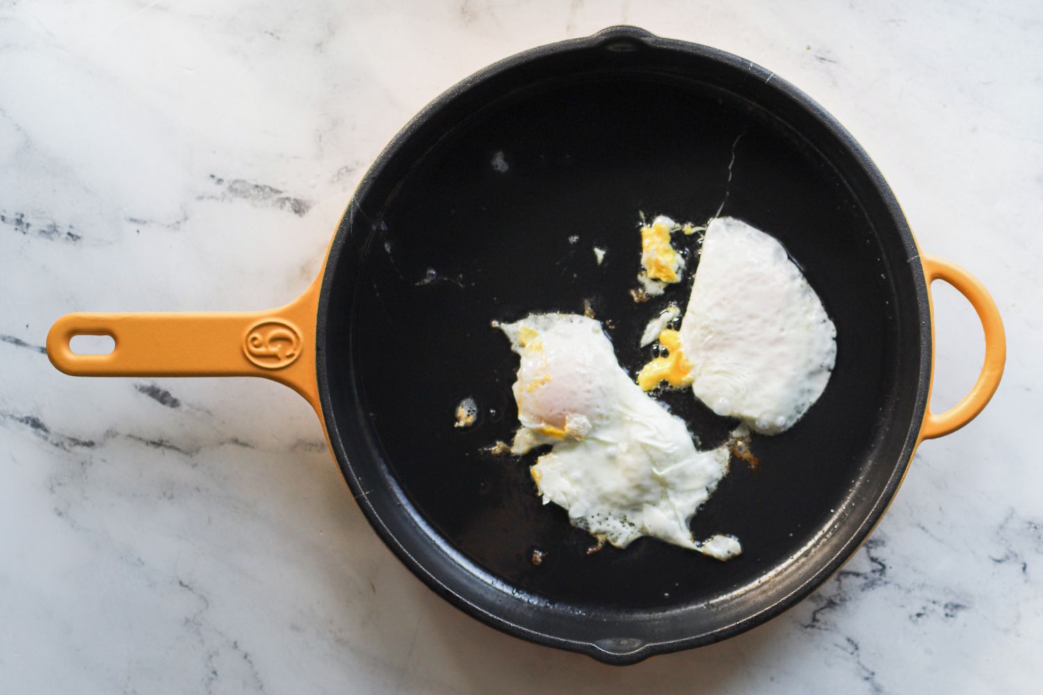 Food inside of the Great Jones 12-Inch King Sear Skillet on a marble background