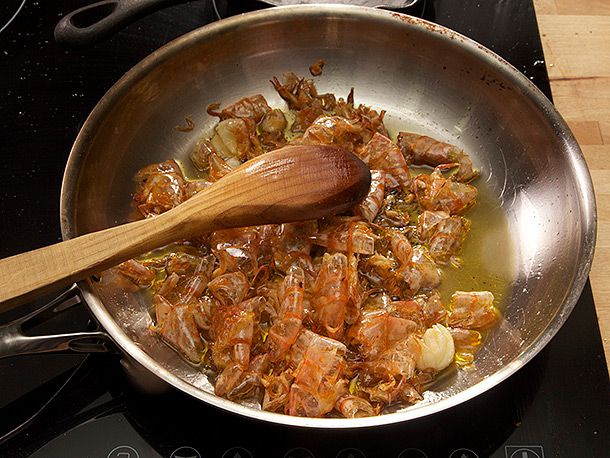Sauteeing shrimp shells in olive oil for Spanish-style garlic shrimp. 