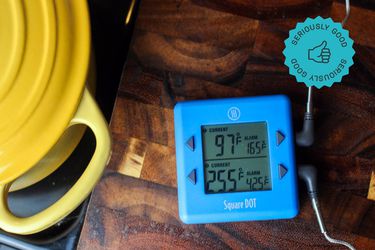 the thermoworks square dot on a wooden cutting board next to a dutch oven