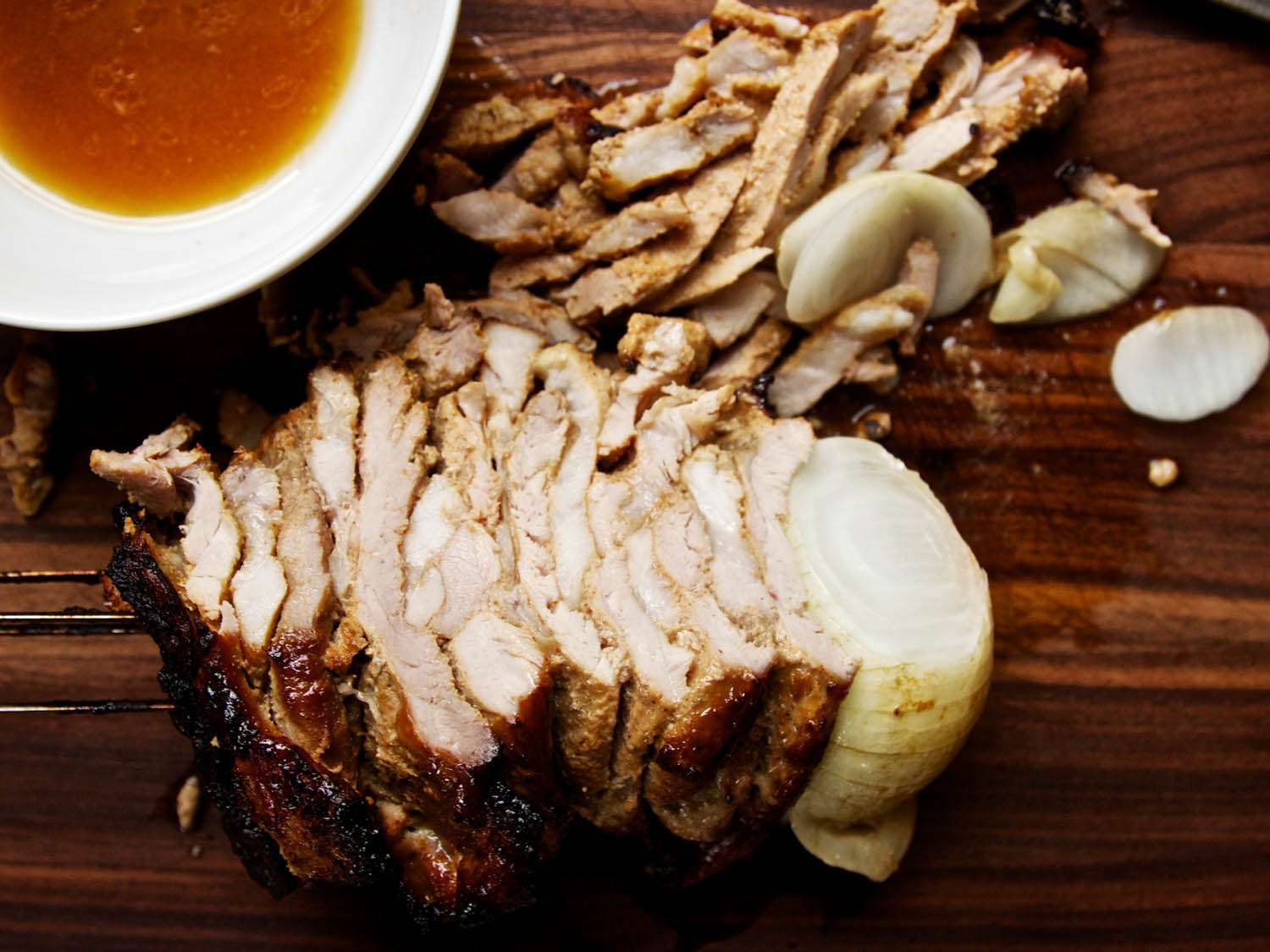 The shawarma skewer, partially sliced into strips of meat.