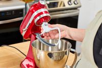 A scraper attachment is added to the KitchenAid Artisan Mini 3.5-Quart Tilt-Head Stand Mixer
