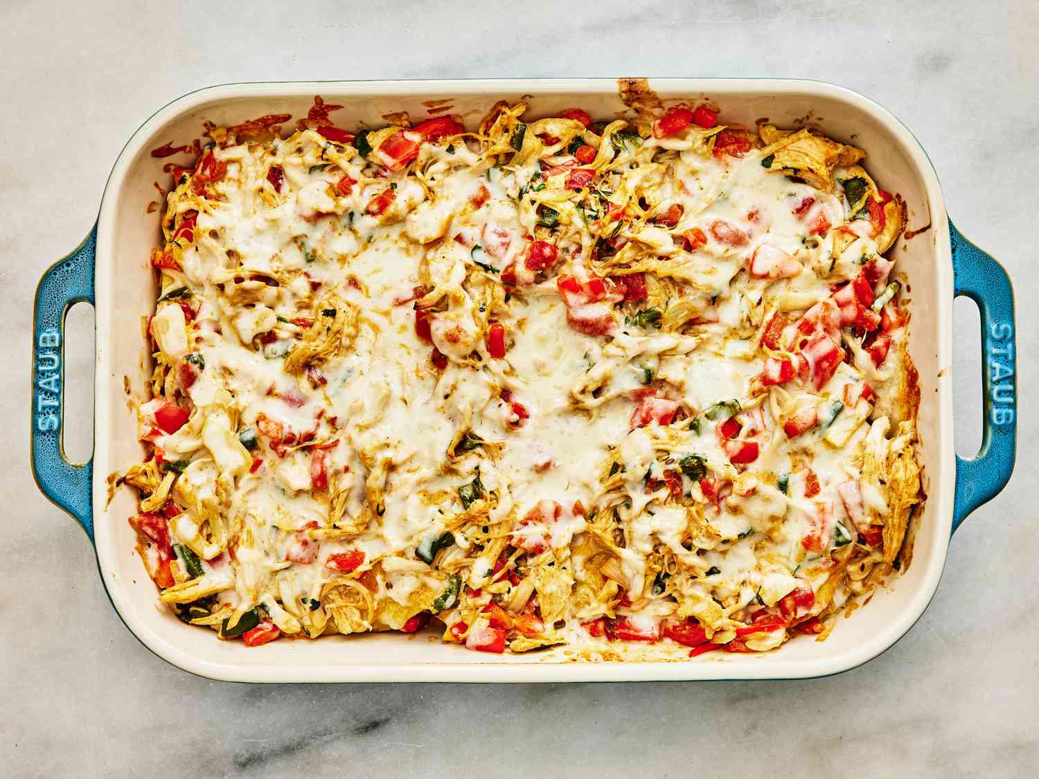 Baked King Casserole in a blue casserole dish on a white marble surface. 