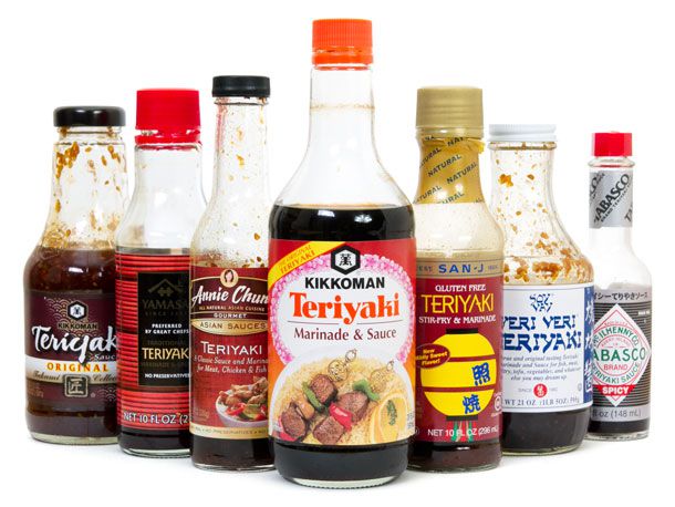 Seven bottles of different brands of teriyaki sauce.