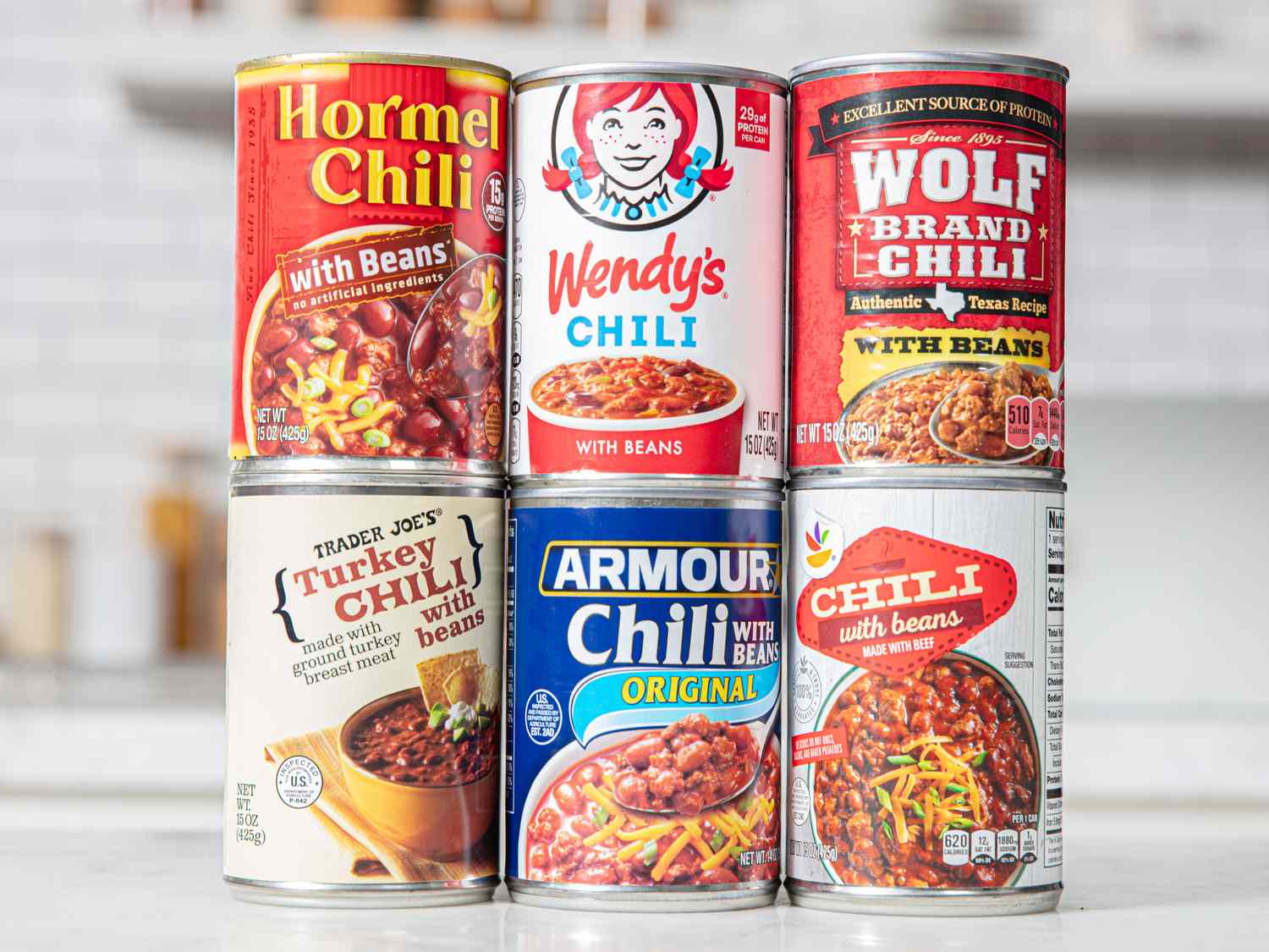 A selection of canned chili brands including Hormel Wendys Wolf Brand Trader Joes Armour and Chili with Beans
