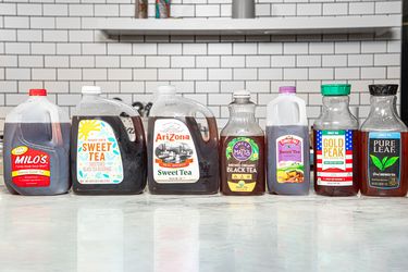 Various branded sweet tea bottles lined up on a counter