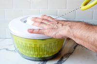 a person pulling the ring on the chef'n spinner