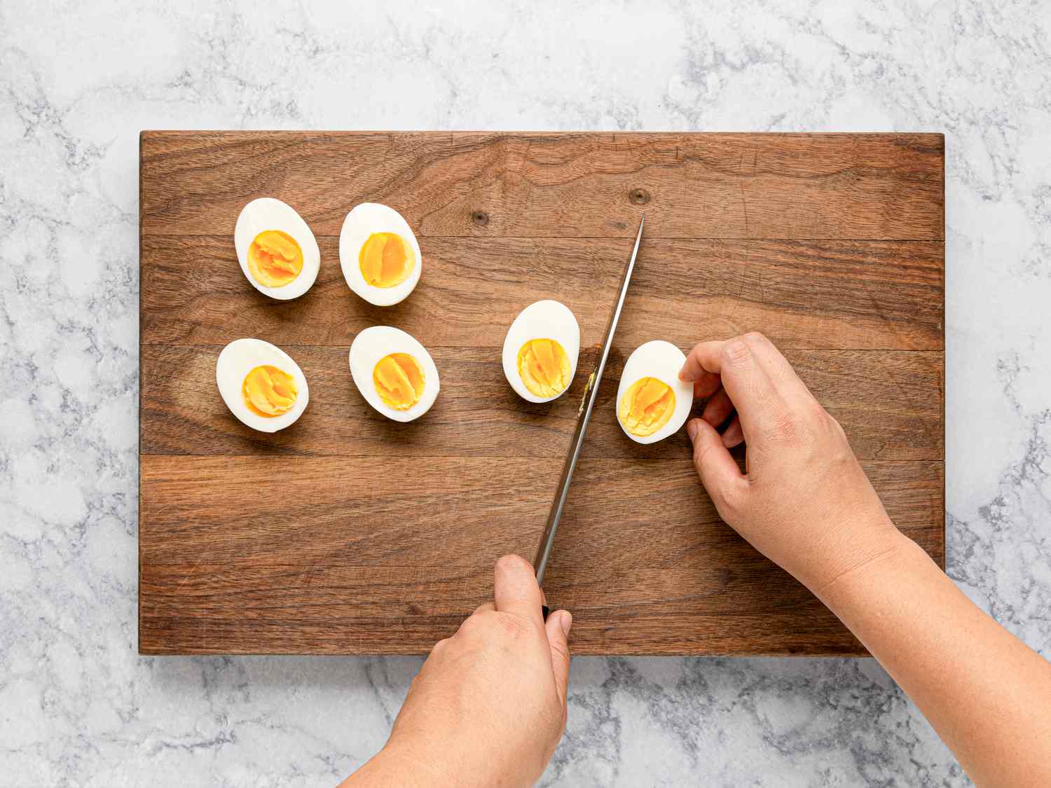 Overhead view of cutting boiled eggs