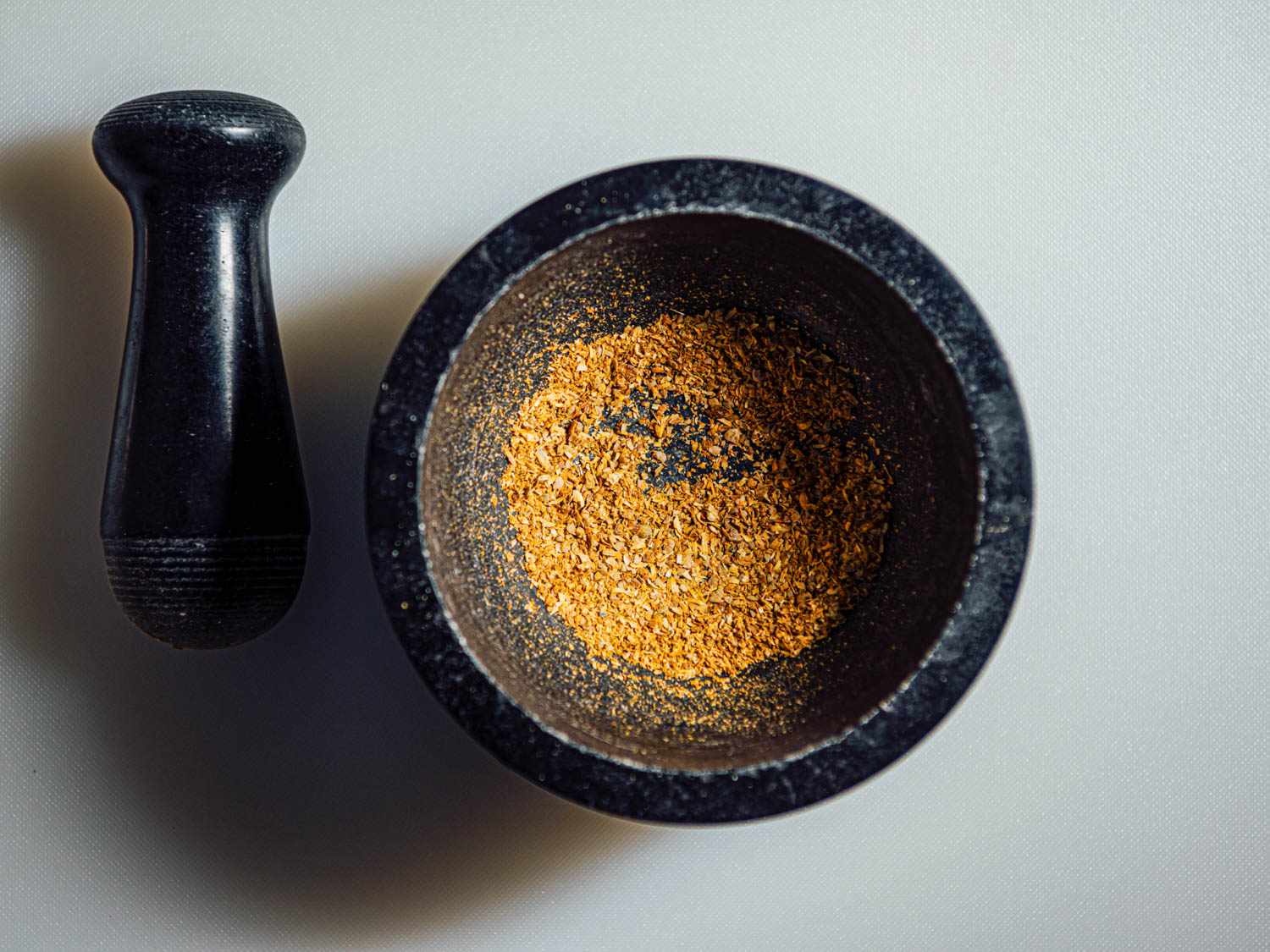 Ground coriander in a mortar.