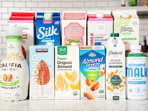 A variety of almond milk brands displayed on a counter