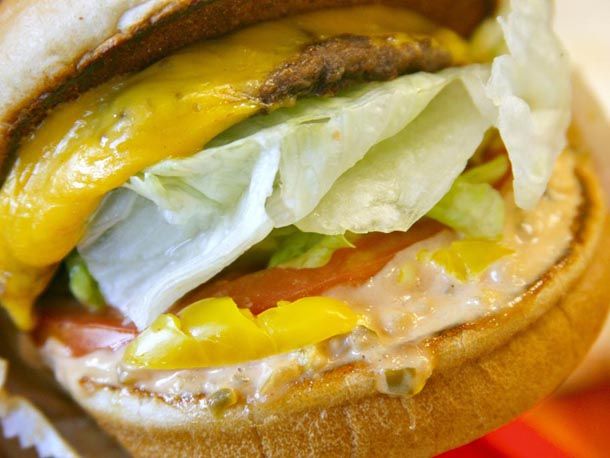 An In-N-Out burger with chopped chiles under the patty