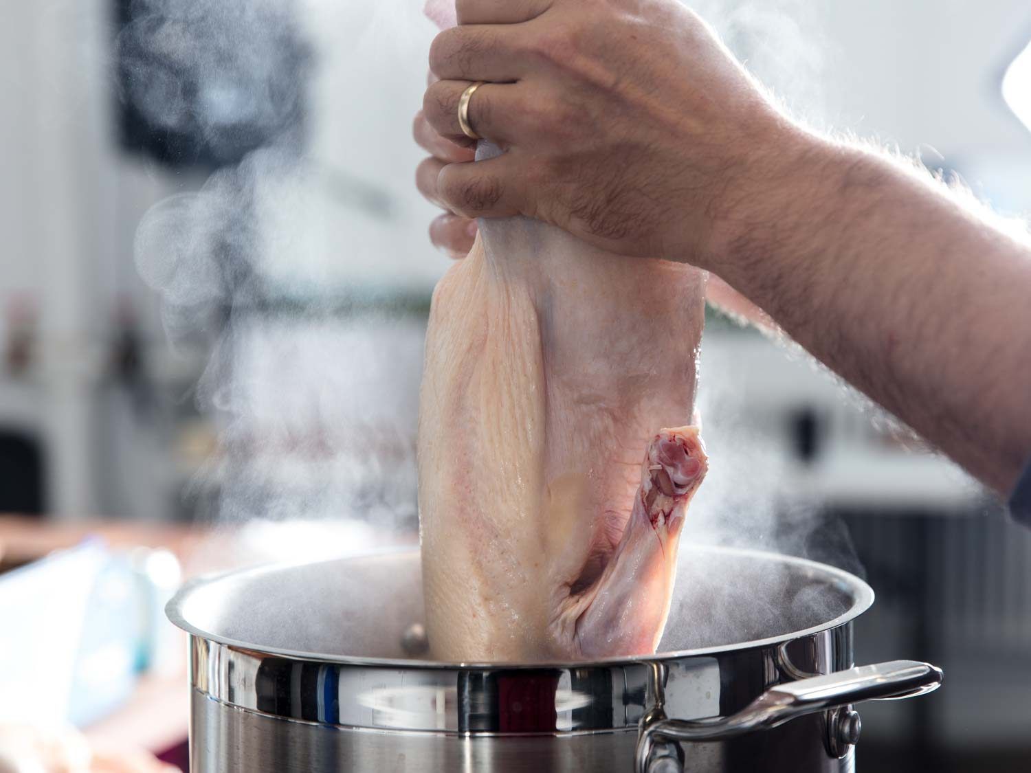Blanching a whole duck before roasting for Duck à l'Orange