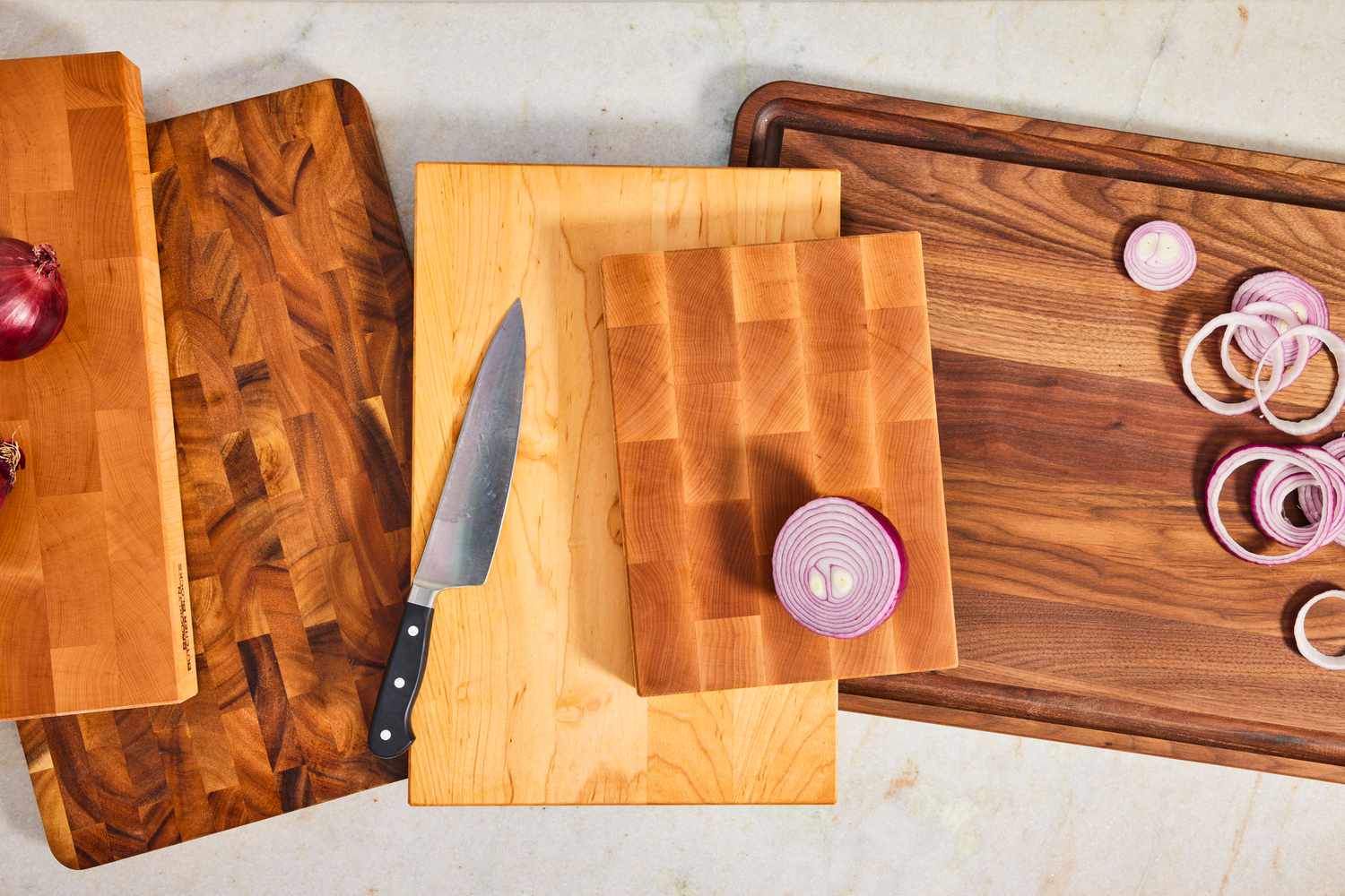 A collection of wooden cutting boards on a white background
