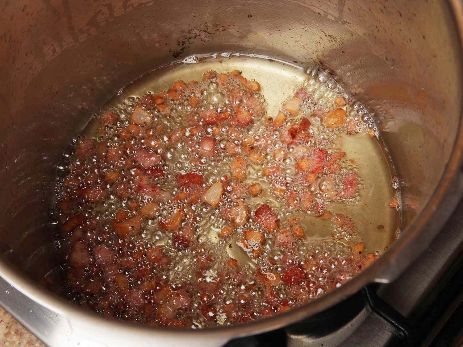Pancetta is rendered and browned in a stovetop pressure cooker.