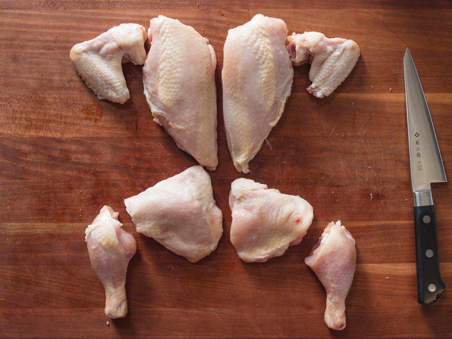 Chicken broken down into 8 pieces.