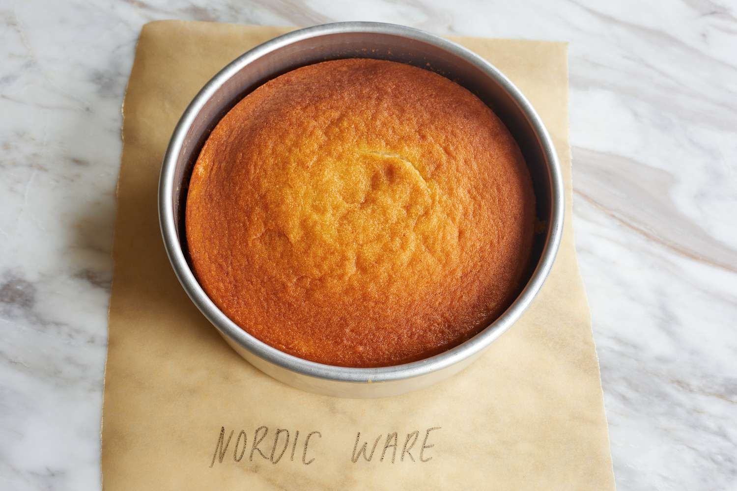 A cake in the Nordic Ware cake pan on a marble surface