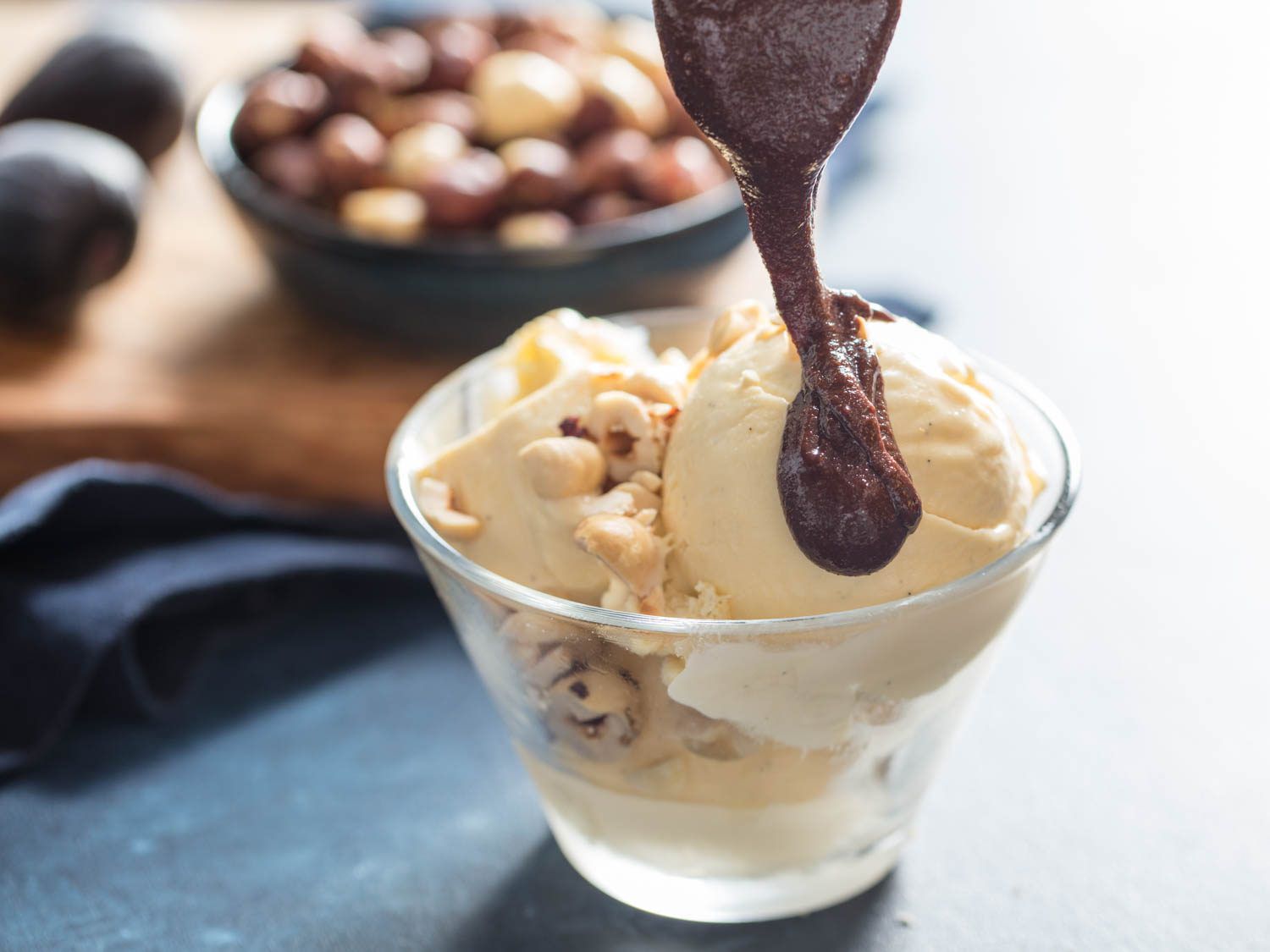 Homemade Nutella being drizzled onto hazelnut ice cream.