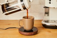 Person pouring coffee into Sweetful Coffee Mug Warmer