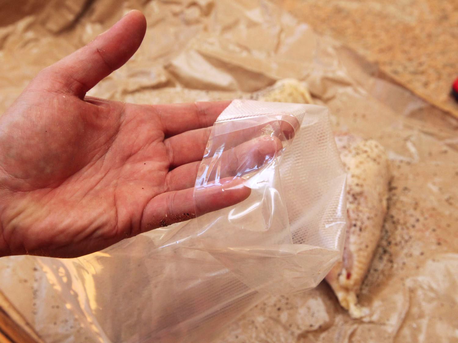 Bagging seasoned chicken breasts before cooking sous vide.