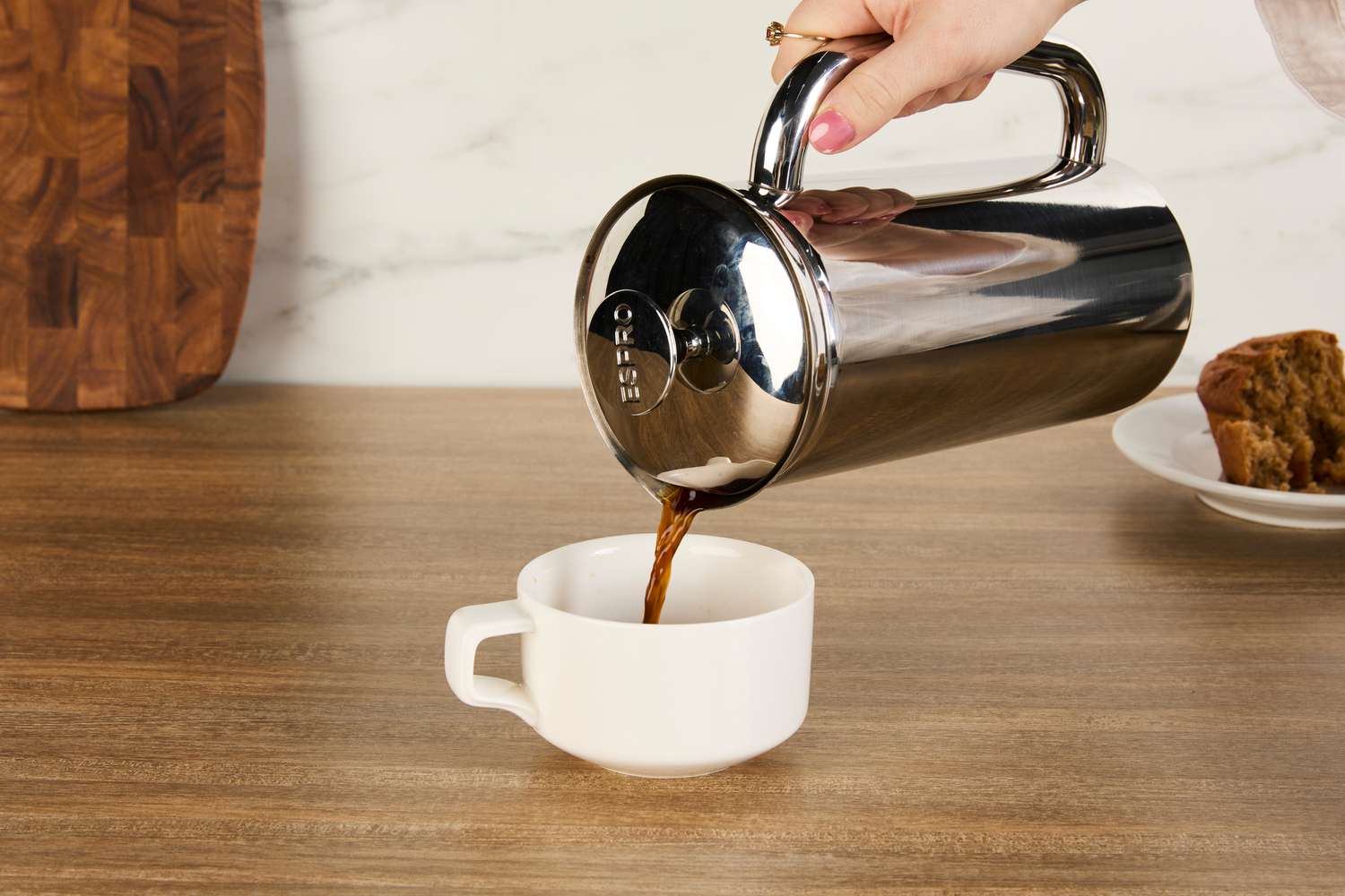 Person pouring coffee into cup with Espro P7 French Press