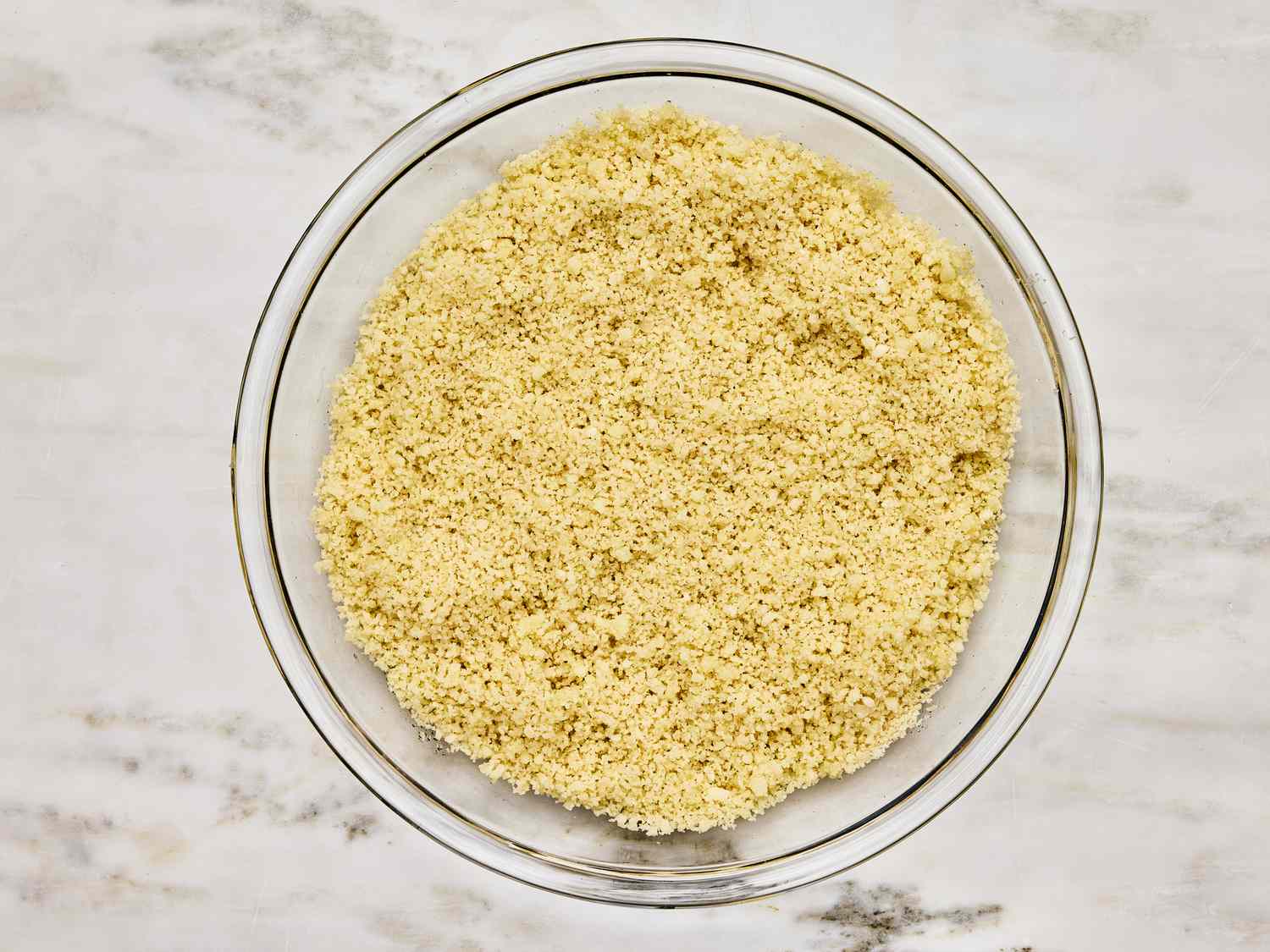 Glass bowl of panko on a marble table top