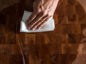 wiping mineral oil over a wood board
