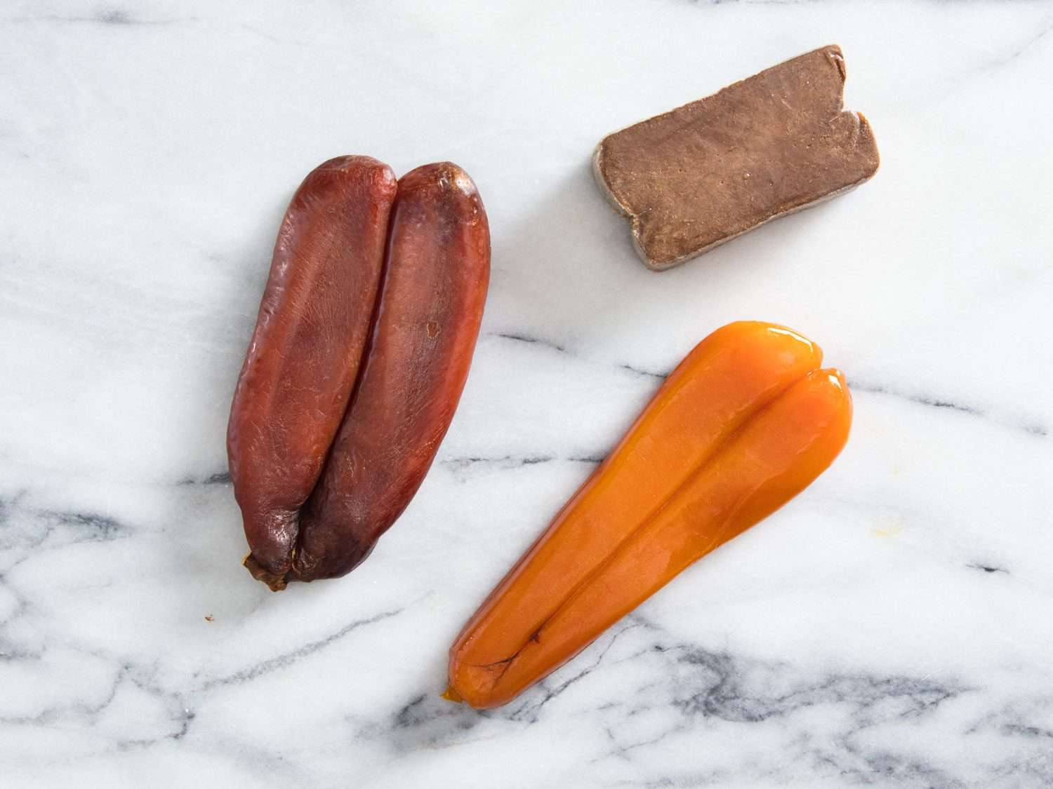 Three examples of bottarga. Clockwise from left: bottarga di muggine from l'oro di cabras; bottarga di tonno; bottarga di muggine from Smeralda.