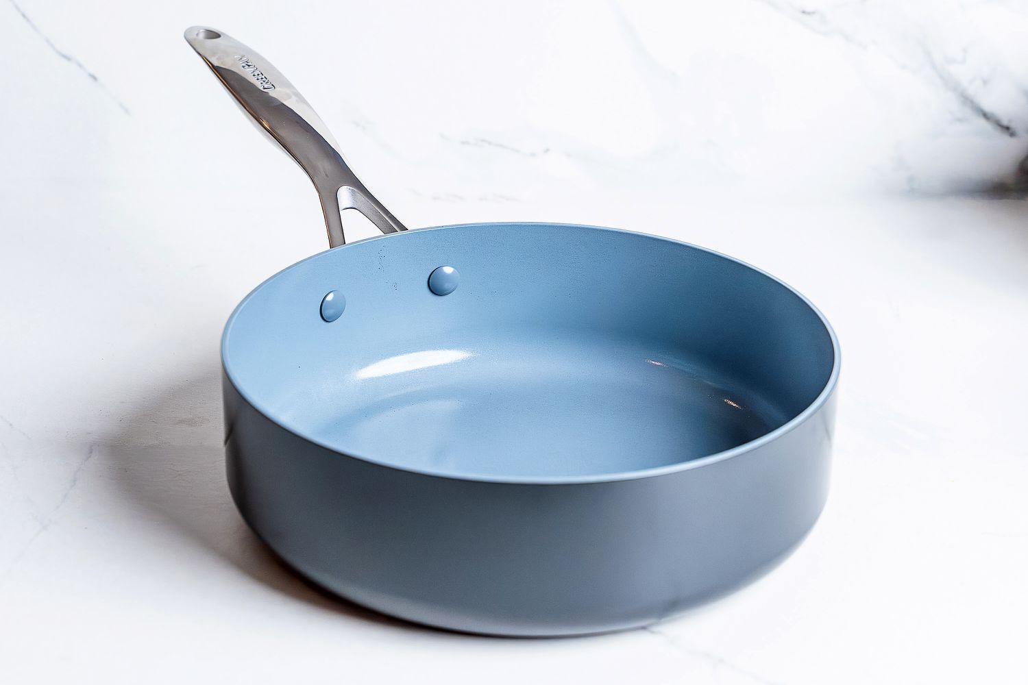 A pot from the GreenPan Valencia Pro Ceramic Nonstick 11-Piece Cookware Set on a white surface