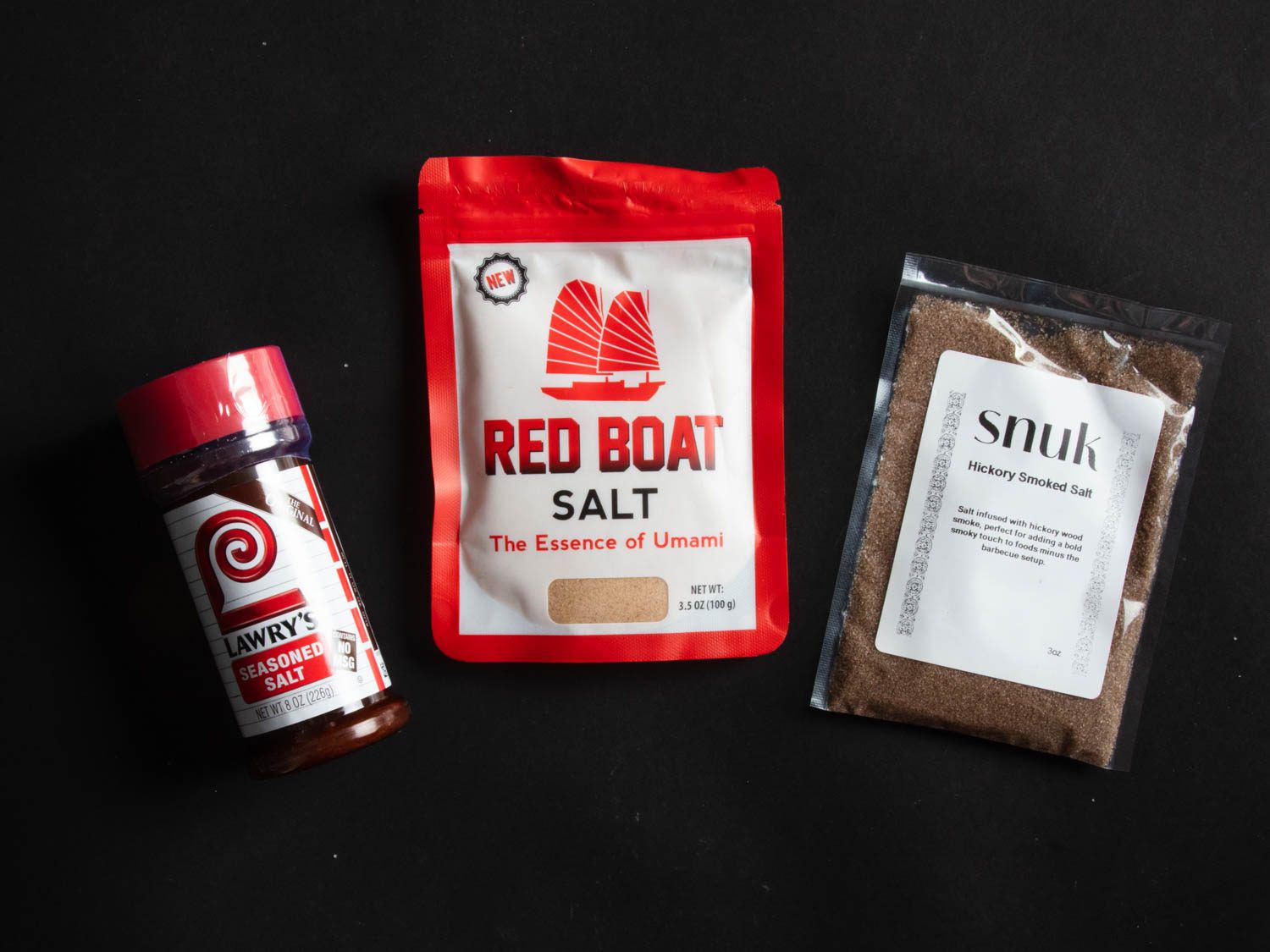 Lawry's seasoned salt, Red Boat Salt, and Snuk hickory smoked salt packages.