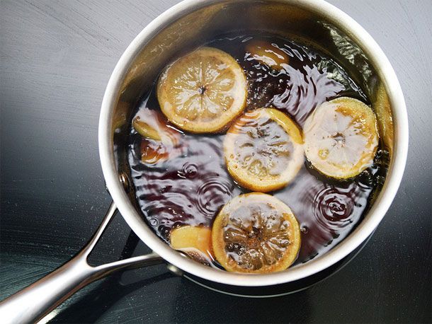 overhead view of boiling coke with lemon slices in saucepan