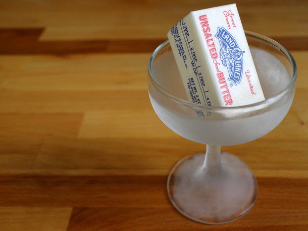A stick of butter inside a chilled cocktail glass. 