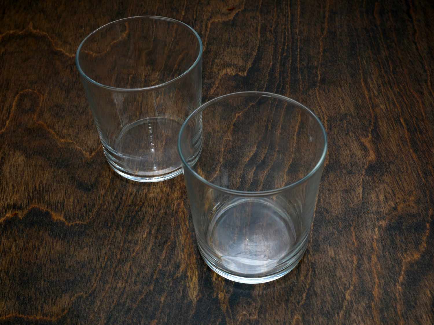 two cups on dark wood surface