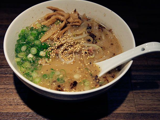 A bowl of kotteri Sapporo-style ramen, topped with bamboo shoots, scallions, bean sprout, and sesame seeds.