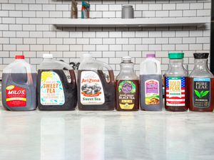 Various branded sweet tea bottles lined up on a counter