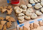 Assorted baked cookies cooling on racks and a table