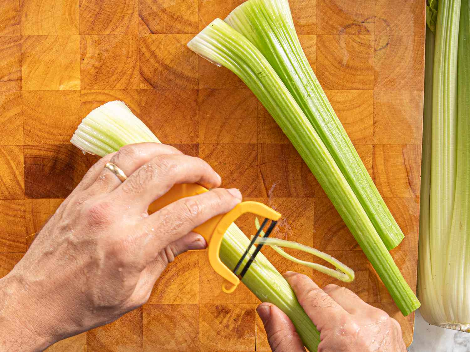 Overhead view of peeling celery