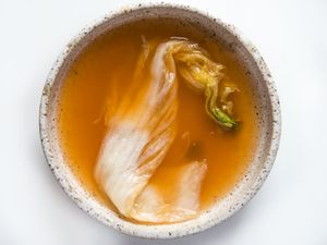 Kimchi in a bowl with broth.