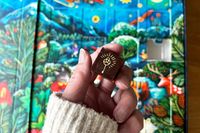 a hand holding a piece of chocolate in front of the Compartés chocolate Advent calendar