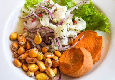 A platter of Peruvian ceviche with boiled corn and sweet potato.